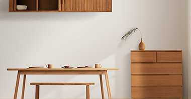 a wooden table, cabinet, shelf and bench created bespokely for the room 