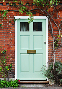 a blue door on the outside of a brick house