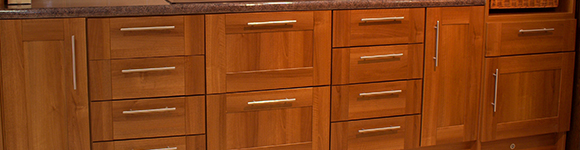 an array of cupboards and draws in a kitchen with a custom wood design
