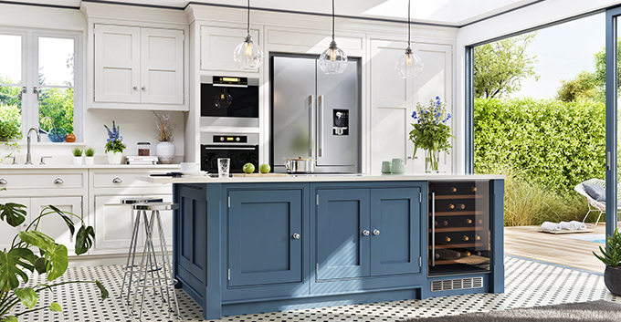 a kitchen with spotted tiles, white and blue fitted cabinets with a sliding door to the outdoors 