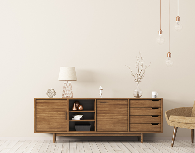 a wooden side table with storage areas, cupboards and draws in a living space 